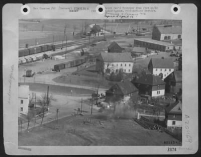 Thumbnail for Consolidated > German Civilians Run For Shelter As A P-47 Thunderbolt Fighter-Bomber Of The Xix Tactical Air Command Swoops Low To Strafe A Rail Yard Near Lingerfild, Germany.  Photo Shows .50 Calibre Bullets Striking A Half Track And A Building Used As Headquarters For