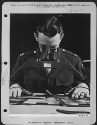 Thumbnail for Consolidated > The photo intelligence officer studies photograph made from the film shot over enemy territory, with the aid of this stereoscopic device. When two prints, made from slightly different angles by the reconnaissance plane, are placed in the proper