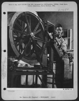 Thumbnail for Consolidated > The great length of wet film is especially vulnerable to damage at this stage, but precious pictures are safely dried on this rotary drier by means of heaters thru which fans blow purified air against the emulsion. Sgt. Joseph Conway, 2072 New York