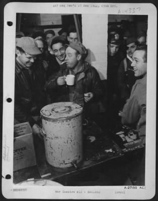 Consolidated > OVATION ON RETURN. Congratulated on the completion of his tour of "ops," T/Sgt. Edward Fee (holding cup) 30, of Charlestown, Mass., is surrounded by flying mates as he awaits interrogation. T/Sgt. Fee, holder of Air Medal and slated for the DFC