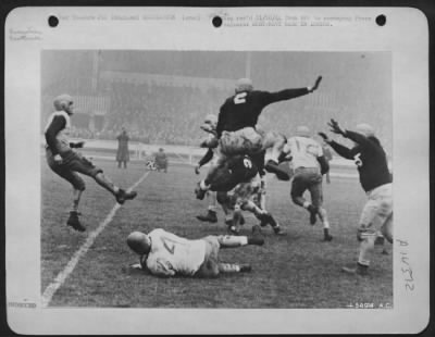 Thumbnail for Consolidated > London gets a preview of the Army-Navy ofotball game when teams representing both services play before 60,000 ofotball hungry Yanks. In this U.S. Army 8th Air force Picture, Boatswain's Mate 2nd Class Joe A La Civita, Stoughton, Mass., Navy