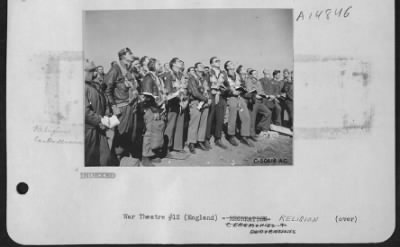 Thumbnail for Consolidated > NINTH AIR force HEADQUARTERS, EUROPEAN THEATRE OF OPERATIONS, 1944--Capt. Lawrence M. Fenwick, Chaplain (right) is shown leading men in prayer during Easter Services at a Ninth Air force station somewhere in England. Capt. Fenwick's home is