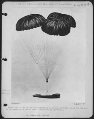 Thumbnail for Consolidated > NEWEST TRICK OF THE AIR SEA RESCUE SERVICE is an airborne lifeboat, dropped from its nest in the bomb-bay of a special plane, & eased down by 3 parachutes.