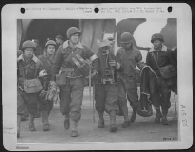 Consolidated > They're so happy to be home! These enlisted technicians of an Evacuation Unit of the 9th AF have been the first to land in France and return with the wounded. Left to right: T/Sgts. Louis Birgantine, Wilofrd Brand, James Gillespie, George