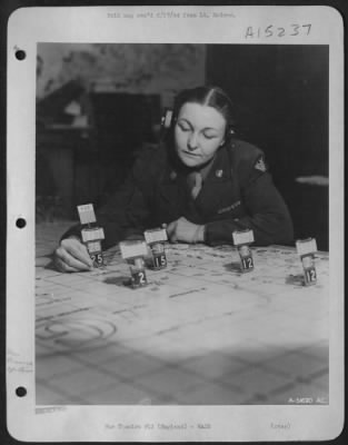 Consolidated > Pvt. Elizabeth K. Hamilton is plotting the courses of bombers over England as they take off on another mission.