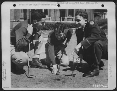 Thumbnail for Consolidated > The Miniature Golf Course, Adjoining A Rest Home Somewhere In England, Is A Big Attraction.  Playing At No. 2 Hole Are (Left To Right) Lt. Leo Danielian Of Los Angeles, Calif.; Lt. Jack N. Danhauer Of Louisville, Ky; And Lt. Bruce Owen Of Duncannon, Penn.