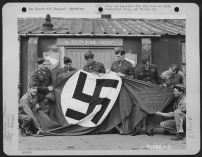 Thumbnail for Consolidated > The Nazi Flag Captured By The Rainbow Division Presented To The 8Th Air Force Is Examined By Men Of The 305Th Bomb Group Based In England.