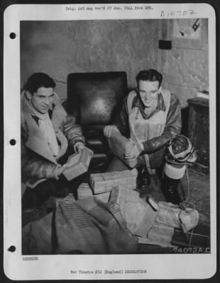 Consolidated > Packages From Home -- Two Fighter Pilots Of The 8Th Air Force Fighter Command Return To Their Base, Somewhere In England, And Are Delighted To See That The Mail Is In And Each Has A Couple Of Packages From Home.  Left To Right, They Are Pilots: Capt. Ralp
