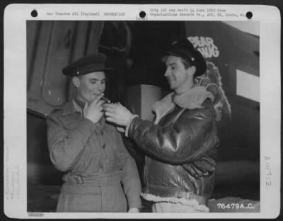 Consolidated > Friendly Relations Are Maintained As An American Air Force Officer Lights A Cigar For A Russian Officer Somewhere In England.  2Nd Base Air Depot, 24 February 1945.