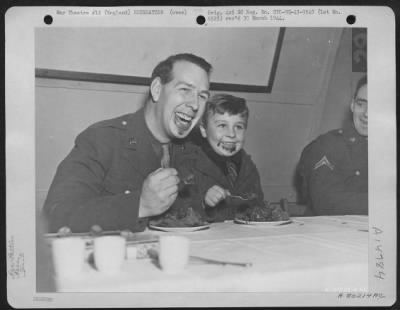 Consolidated > Pvt. George Alton, Turtle Creek, Penn., And Harry Himmas, Son Of A British Solider, Eat Ice Cream At A Christmas Party Given By The Soliders Of The Tactical Depot, 9Th Air Service Command For Orphans And Sons And Daughters Of British Soldiers, At Berks, E