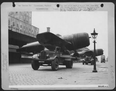 Consolidated > Re-Deployment -- Fighter Planes - After Dissasembly And Taping, The Now Dingy Looking Republic P-47 Thunderbolts Are Hauled Through The Streets Of Liverpool To The Docks.  This Is A Touchy Business For Many Spots On The 8 Mile Trip From Speke To The Docks