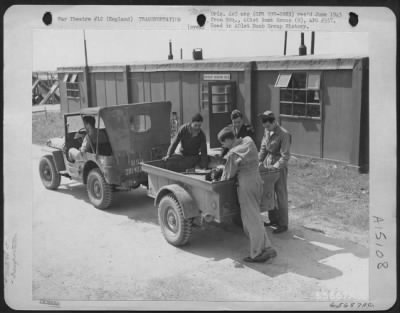 Consolidated > Men Assigned To 401St Bomb Group Load Equipment Into 2 Wheeled Trailer At An 8Th Air Force Base In England.  15 August 1944.