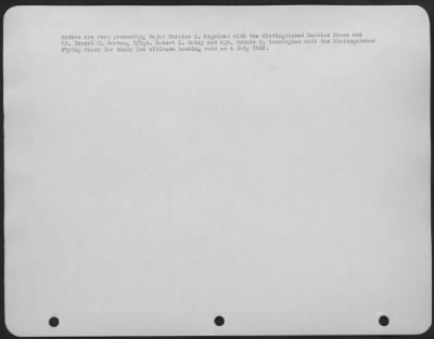 General > Orders are read presenting Major Charles C. Kegelman with the Distinguished Service Cross and Lt. Randal M. Dorton, T/Sgt. Robert L. Golay and Sgt. Bennie B. Cunningham with the Distinguished Flying Cross for their low altitude bombing raid on