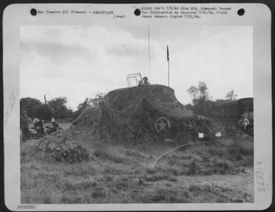 General > Carefully camouflaged, this mobile control tower directs incoming and outgoing traffic at the first American airfield in Normandy. The field, built by members of the 9th Engineer Command, is already in operation refueling and servicing fighters
