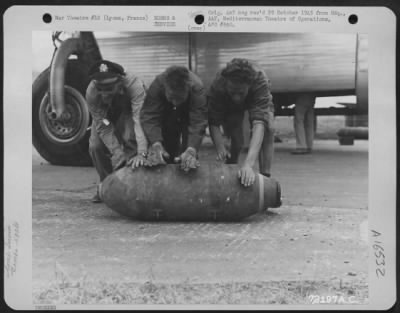 Thumbnail for General > An American And Two British Airmen Roll A 500 Lb. Bomb From A Consolidated B-24 Liberator Of The 15Th Air Force, To A Supply Dump At Lyons, France.  The Planes Ferry Gas And Supplies From A Base In Italy To The Base At Lyons.  13 September 1944.