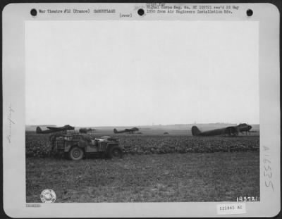 General > Two American Officers Look Over A Field Of Decoy Ju-88S, Dummy Planes Used As 'Bait' On A Former Nazi Airport At Epinay, France.  These 'Prop' Planes Were Parked On A Section Of The Field Where Bombs Dropped By Allied Bombers Would Do The Smallest Amount