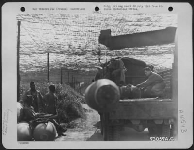 General > Enlisted Men Load Bombs Onto A Truck At A Camouflaged Bomb Dump, France.