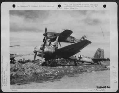 General > A Member Of The 439Th Troop Carrier Looks Over A Captured German Junkers Piggy Back Plane [Junkers Ju 88 And Focke Wulf Fw 190] At An Air Base Somewhere In France.  4 May 1945.