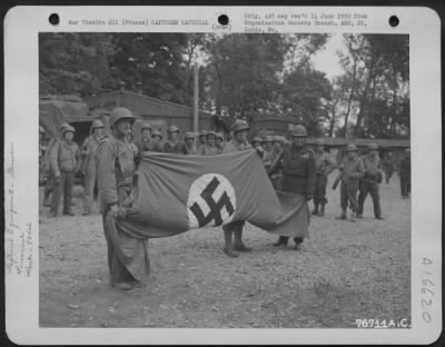 General > Colonel Mccavley, Air Corps, Colonel Karl B. Shilling, Corps Of Engineers, And Major General Ralph Royce Hold Up A Nazi Flag Which Was Captured By Men Of The 834Th Engineer Aviation Battalion At St. Pierre Du Mont, Normandy, France.