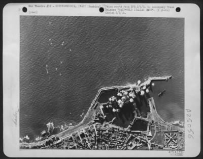 Thumbnail for Consolidated > With their forms hardly more visible than tiny specks against the waters of Tyrrhenian Sea, no less than 12 B-25 Mitchell bombers of the U.S. Army 12th Air Force may be seen wheeling away from the harbor installations of Civitavecchia, 35 miles