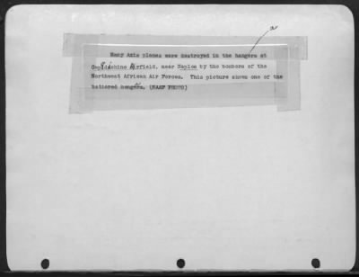 Consolidated > Many Axis planes were destroyed in the hangars at Capiodichino Airfield, near Naples by the bombers of the Northwest African Air Forces. This picture shows one of the battered hangars.