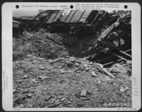 Bomb damage to rail line and cars in the harbor area at Piombino, Italy. 30 June 1944. - Page 1