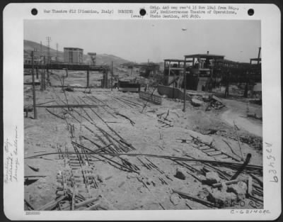 Consolidated > Bomb damage to rail line and other installations in the harbor area at Piombino, Italy. 30 June 1944.