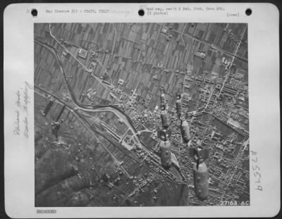 Consolidated > 12TH AIR FORCE, December 26-- "BOMBS AWAY" and another Axis target feels the impact of power ful AAF attacks, as shown in the pictures. Marshalling yards at Prato, Italy, are shown before and after bombs are dropped from Martin B-26 Marauders