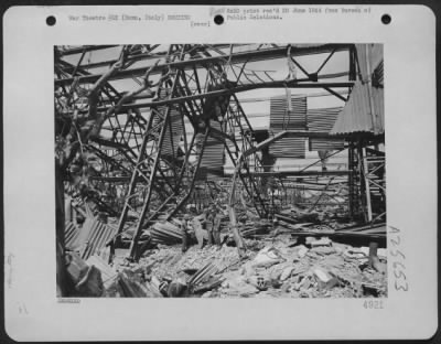 Thumbnail for Consolidated > Air Force personnel inspect damage done to a hangar at Ciampino Airfield near Rome, Italy. The building was demolished during a bombing raid by the Mediterranean Army Air Forces.