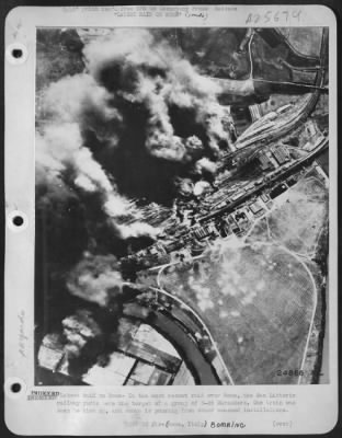 Consolidated > Bomb bursts may be seen on the airfield in the lower right, bordering the Tiber River. Some enemy aircraft are dispersed on the ground and in revetments along the edge of the field. Such revetments are usually made of concrete, and serve to protect