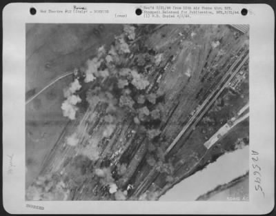Consolidated > This picture, taken at the height of the attack by B-17 Flying Fortresses of the 15th AAF on the Rome/Littorio railroad yards 3 March, shows strings of high-explosive bomb bursts across the target. Much of the rolling stock present was destroyed or