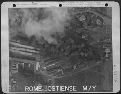 Consolidated > BLASTING NAZI RAIL COMMUNICATIONS THROUGH ROME AND FLORENCE, ITALY. American bombing raids show how, with precision bombing, men of the U.S. Army 12th AF strike military targets. Heavy smoke billows up from bombs