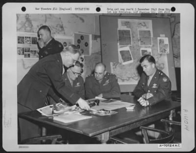 General > Brig. Gen. Howard M. Turner, Gen. Carl A. Spaatz And Lt. General James H. Doolittle Discuss 8Th Air Force Operations During The Latter'S Visit To Hdq., 1St Bomb Division, Based In England On 31 March 1945.