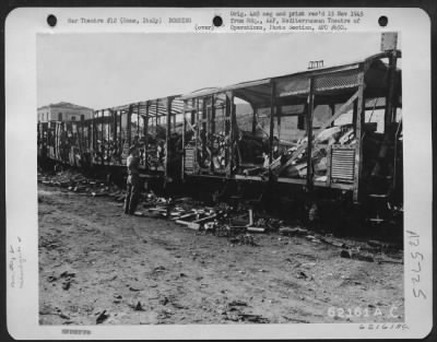 Consolidated > Bomb damage to rail cars north of Rome, Italy.