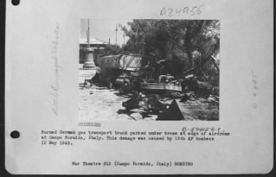 Consolidated > Burned German Gas Transport Truck Parked Under Trees At Edge Of Airdrome At Campo Formido, Italy.  This Damage Was Done By The 15Th Air Force Bombers.  12 May 1945.