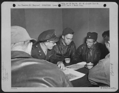 General > Capt. John K. Rickles Of Indianapolis, Ind., (Profile To Camera) Intelligence Officer Of The 91St Bomb Group At Bassingbourne, England, Interrogates Crew Members After Their Return From A Mission Over Enemy Territory.  The Men Are, Left To Right: 1St Lt.