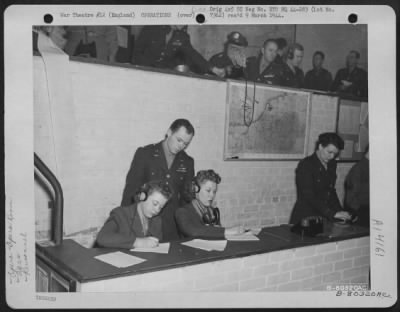 General > Colonel Eugene P. Roberts, Standing, Of Spokane, Wash., Watches Wac Pfc. Sylvia Gilbertson Of Grand Forks, N.D., And Pfc. Thelma Frisch Of Great Falls, Mont., At Work In The Operations Room At An 8Th Air Force Base At Watford, England.  11 January 1944.