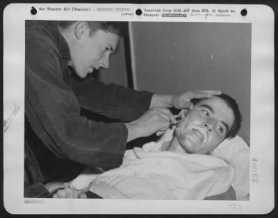 General > T/3 Wm J. Eldridge Of Eldridge, Ky., Removes A Two Month Stubble From His Buddy T/3 James Cruise Of Brockton, Mass., On Board The Launch Which Brought Them From Albania After Their Plane Had Been Forced Down.