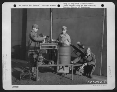 General > Personnel Of The 2Nd Bomb Division Used Ingenuity In Constructing This Washing Machine From Spare Parts.  Here They Assist Each Other In The Washing Of Their Clothes.  29 November 1943.