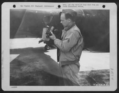 Cameras,Gun > A Crew Member Of The 96Th Bomb Group Checks A Gun Camera Of A Republic P-47 At An 8Th Air Force Base In England.  6 July 1943.