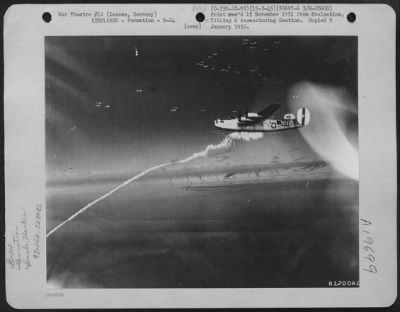 Consolidated > A Smoke Marker Is Dropped By The Bombardier In The Lead Plane To Mark The Target For Formations Of Consolidated B-24S During A Raid On Zossen, Germany On 15 March 1945.