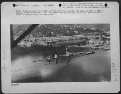 Thumbnail for Consolidated > Italy - Large Passenger Vessel Lies Awash In Harbor At La Spezia, Sunk Either By 12Th And 15Th Af Bombings Or By German Demolitions.  This Picture Was Taken Of The Italian Naval Base Immediately After Its Occupation By Fifth Army Troops.