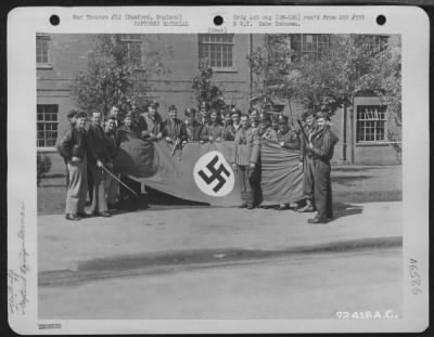 General > Pilots Of The 82Nd Fighter Squadron, 78Th Fighter Group, Holding A Captured Nazi Flag, Pose For The Photographer At 8Th Air Force Station F-357 In Duxford, England.  18 June 1945.