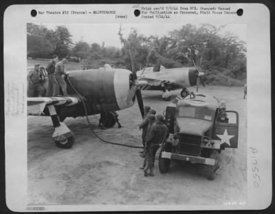 Thumbnail for Refueling > While the pilot, Lt. Alfred W. Martin, of Detroit looks on, servicemen of the 8th AF Service Command give this Republic P-47 a complete service job. These soldier-technicians are refueling, rearming, and checking the ground support planes at air