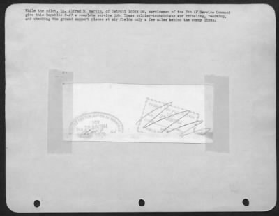 Thumbnail for Refueling > While the pilot, Lt. Alfred W. Martin, of Detroit looks on, servicemen of the 8th AF Service Command give this Republic P-47 a complete service job. These soldier-technicians are refueling, rearming, and checking the ground support planes at air