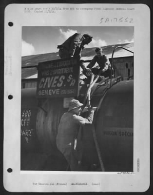 Thumbnail for Refueling > Brig. General Gordon P. Saville, Commanding General of the XII Tactical Air Command helps American ground crewmen load aviation gasoline into a tank car that will take it to our most advanced air bases in Southern France.