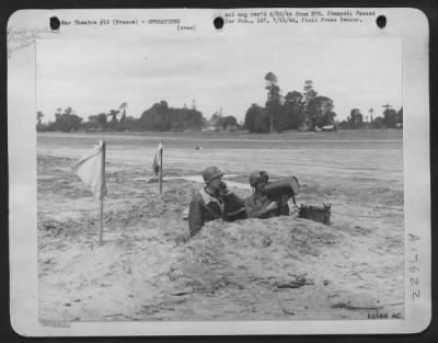 General > Traffic control men, working from a foxhole on a 9th Air Force airstrip somewhere on the Normandy peninsula, signal with their "biscuit gun" to a pilot about to take-off. This strip was made ready by 9th Aviation Engineers of the 9th Air Force.