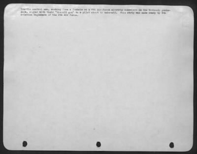 General > Traffic control men, working from a foxhole on a 9th Air Force airstrip somewhere on the Normandy peninsula, signal with their "biscuit gun" to a pilot about to take-off. This strip was made ready by 9th Aviation Engineers of the 9th Air Force.