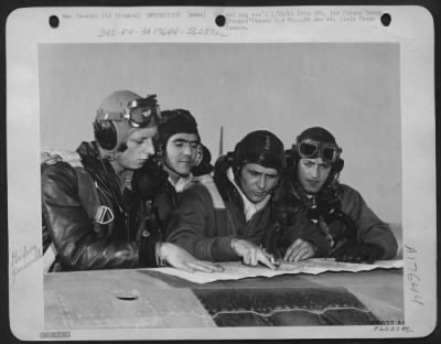 Thumbnail for General > Lt. Col. Marshall Cloke, (second from right) a squadron commander in the 354th fighter-bomber group, checks last minute details with his flight-leaders just before an attack against German supply and communications lines. The scene is a front line