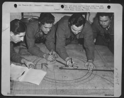 General > The operations room of a searchlight platoon where men follow the course of enemy aircraft and vector lost planes to their home bases. L. to R.: Pvt. Michael Petrisko, Barnesbora, Pa., Pfc. Thomas Mitchell, Quincy, Fla., Pfc. Fred Green, La Grange